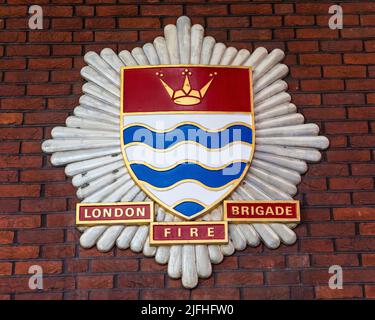 London, UK - March 8th 2022: Close-up of the London Fire Brigade badge on the exterior of Soho Fire Station in London, UK. Stock Photo