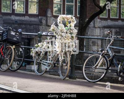 Decorated bicycle on Singel Canal in Amsterdam Stock Photo