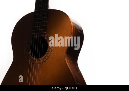 Spanish classical guitar close up, dramatically lit on a white background with copy space. Stock Photo