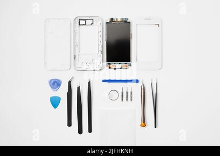 Repairman workplace with phone and tools, flat lay Stock Photo