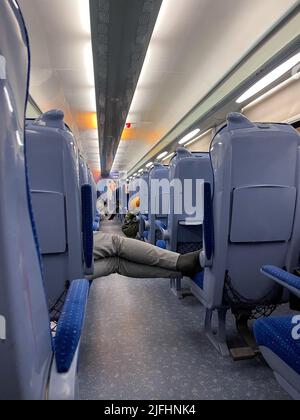 Unrecognizable man sleeps in the train Stock Photo