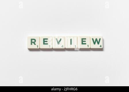 Review formed of scrabble elements on white background. Stock Photo