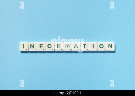 Information formed of scrabble blocks on blue background. Stock Photo