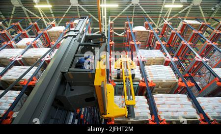 Storage.Creative.A man who arranges boxes and uses special vehicles for delivery. Stock Photo