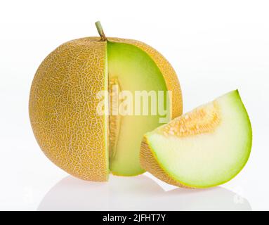 Yellow ripe melon and melon slice isolated on white bright background. Melon is reflected on white glossy surface. Stock Photo