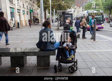 05-09-2016  Nantes France. Nantes street with seated ethnically African mother and her son in stroller Stock Photo