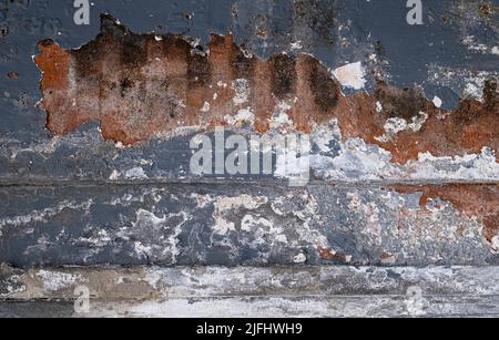 Old and peeling blue and white painted brick wall in Bali, Indonesia. Background grunge texture Stock Photo