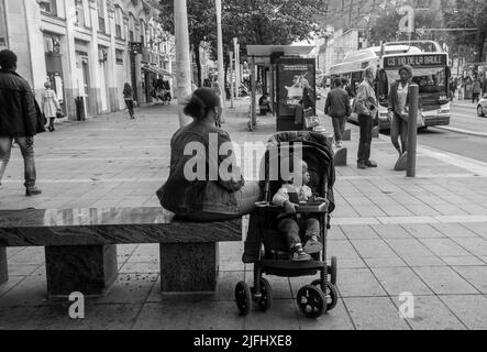 05-09-2016  Nantes France. Nantes street with seated ethnically African mother and her son in stroller Stock Photo