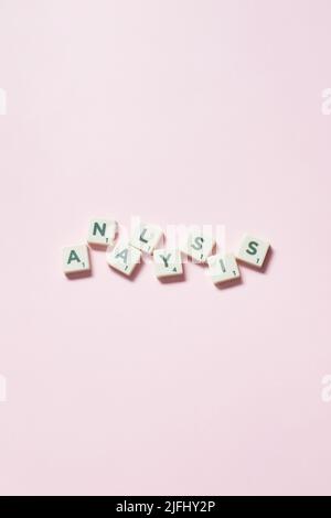 Analysis formed of scrabble blocks on pink background. Stock Photo