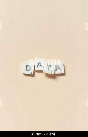 Data formed of scrabble blocks on beige background. Stock Photo