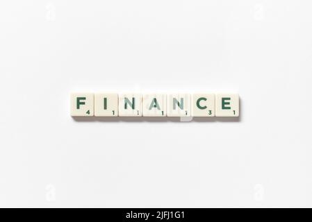 Finance formed of scrabble blocks on white background. Stock Photo