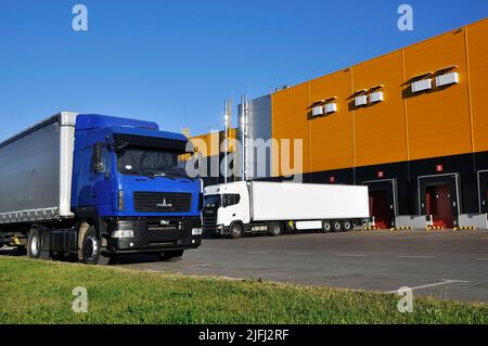 Modern logistics complex. Unloading trucks in a modern warehouse. Stock Photo
