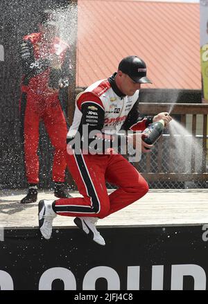 Akron, United States. 03rd July, 2022. Scott McLaughlin (3) jumps off the stage as he celebrates winning the Honda 200 at the Mid Ohio Sports Course in Lexington, Ohio on Sunday July 3, 2022. Photo by Aaron Josefczyk/UPI Credit: UPI/Alamy Live News Stock Photo
