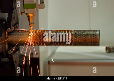 Laser cutting machine working with metal workpiece with sparks Stock Photo