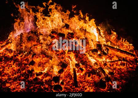 Burning coals from a fire abstract background. Stock Photo