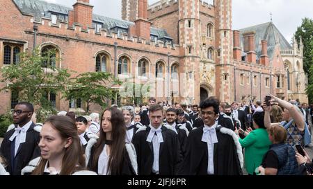 Cambridge graduates from Trinity College leave their college to attend the graduation ceremony this morning at Senate House.   Image shot on 29th June Stock Photo