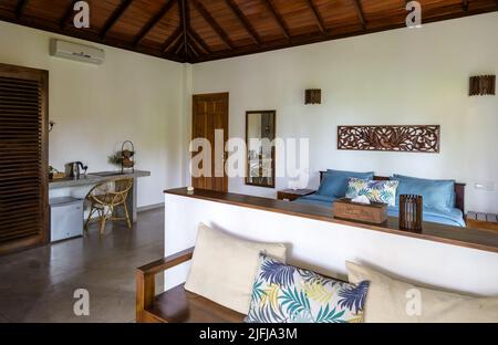 Tangalle, Sri Lanka - Nov 1, 2017: Hotel or home interior in Indian minimalist style. Inside residential house on tropical beach. Typical furniture wi Stock Photo