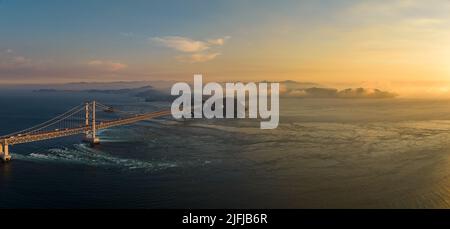 Panoramic aerial view of Naruto Bridge and whirlpools at sunset Stock Photo