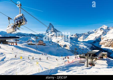 Alpine landscape with chairlift station of ski resort at foot of Matterhorn peak Stock Photo