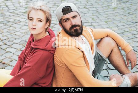 Youth fashion. Feeling free and stylish. Man and woman modern clothes for youth relaxing outdoors. Forever young. Couple hang out together. Carefree p Stock Photo