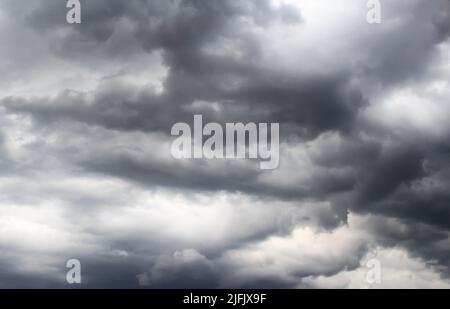 Dark storm clouds before rain, with strange cloud shapes Stock Photo
