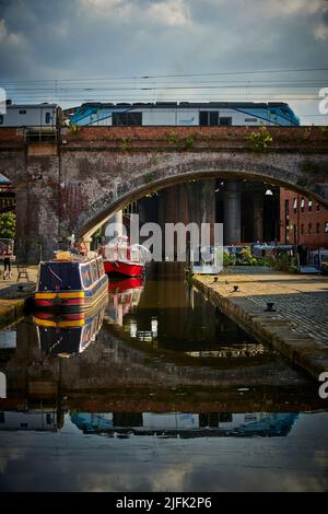 Castlefield Basin in Manchester city centre, British Rail Class 68 TransPennine Express (TPE) passing on the viaduct Stock Photo