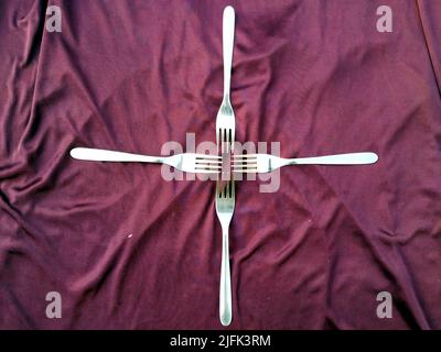 Empty  Steel Fork isolated on violet  background Stock Photo