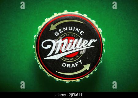 June, 2017 - Ankara, Turkey: Close up macro miller beer bottle cap on green background. Stock Photo