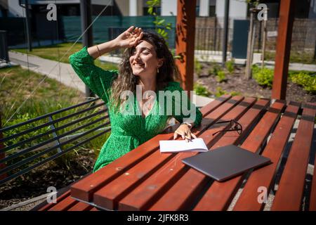 Caucasian woman drawing ideas on a notebook outside office.  Stock Photo
