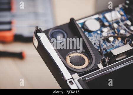 Closeup broken spaker inside the old computer. Computer service and repair concept. Stock Photo