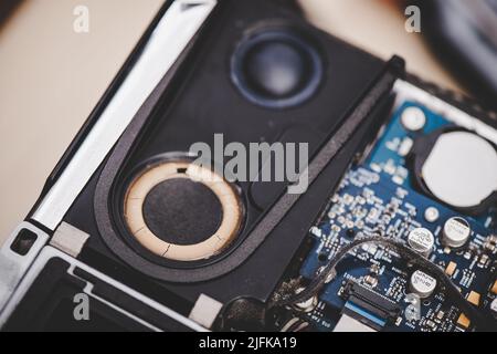 Closeup broken spaker inside the old computer. Computer service and repair concept. Stock Photo