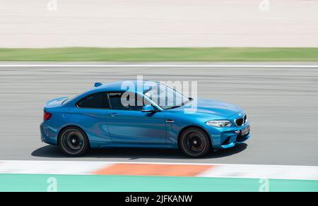 blue colored BMW M2 running on the Valencia racing circuit Stock Photo
