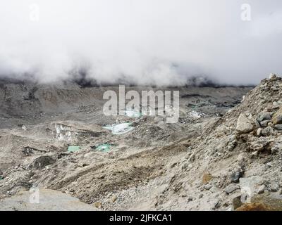 Low May clouds over the Khumbu Glacier north of Lobuche, Nepal Stock Photo