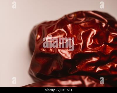 Close up of a dry jujube fruit. Also called red date, Chinese date, and Chinese jujube, is a species in the genus Ziziphus. Stock Photo