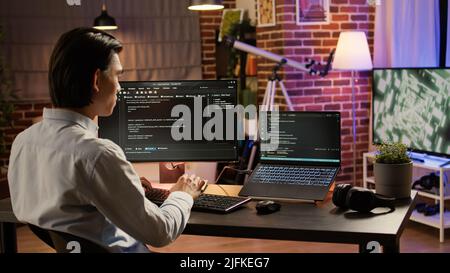 Asian programmer using binary code to script security system ...