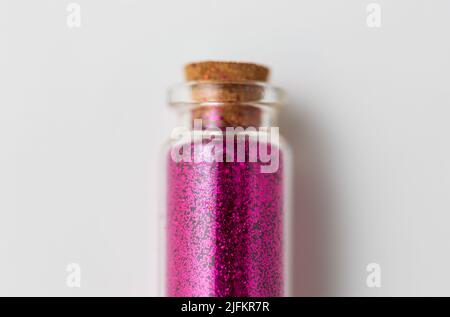 pink glitters in bottle over white background Stock Photo