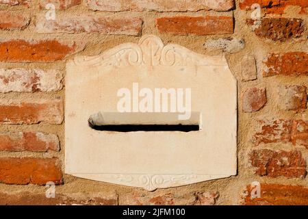 Old mailbox on a red brick wall as bakground Stock Photo