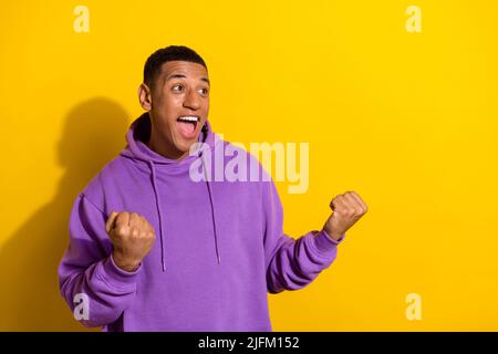 Portrait of attractive satisfied cheerful guy rejoicing having fun copy space isolated over vivid yellow color background Stock Photo