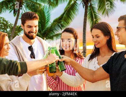friends toasting non alcoholic drinks on beach Stock Photo