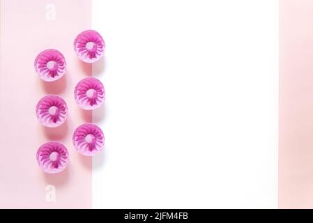 https://l450v.alamy.com/450v/2jfm4fb/pink-silicone-molds-for-cupcakes-and-muffins-on-a-pink-background-2jfm4fb.jpg