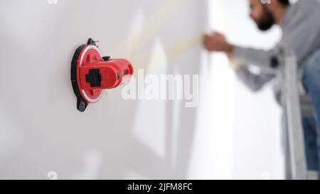Builder using professional measuring device for marks Stock Photo