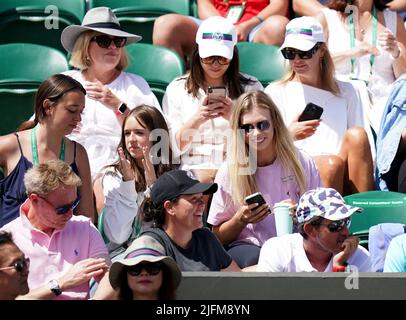 Katie Boulter (centre, right) watching Alex de Minaur on day eight of ...