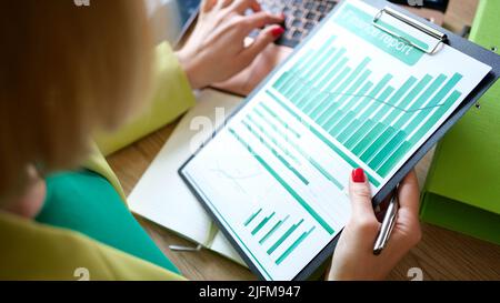 Woman accountant using laptop and making financial report Stock Photo