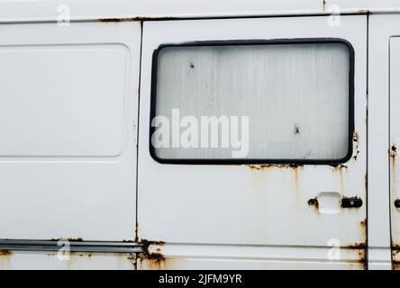 White rusty abandoned compact van. old grunge car Stock Photo