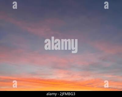 Sunset sky with colorful clouds background concept. Evening sunset in the city. Empty beautiful red orange sky view twilight time of Istanbul, Turkey. Stock Photo