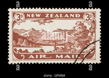 A New Zealand air mail stamp from 1931, depicting a plane flying over a New Zealand landscape Stock Photo