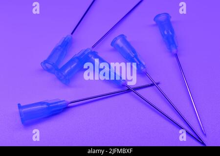 Medical syringe's needles compilation on a violent background. Social problems.  Drugs and medical treatment. Stock Photo