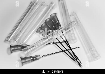 Medical syringe's needles compilation on a white background. Social problems.  Drugs and medical treatment. Black and white. Stock Photo
