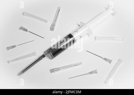 Medical syringe and needles compilation on a white background. Social problems. Vaccine against corona virus and monkeypox. Drugs and medicine. Stock Photo