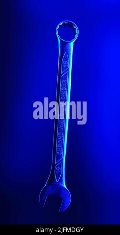 Blue Spanner for 19 made of chrome vanadium steel flying in the air on a blue background. Background picture. Isolated spanner. Stock Photo